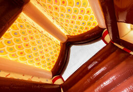 Dach krytego zamku dmuchanego udekorowane jak piernikowy domek w temacie piernika